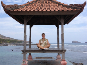 Joan Reid Healing Arts Studio performing yoga on a beach